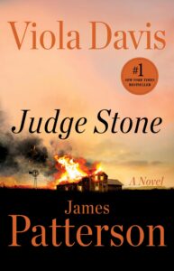 The cover features a farm house on a prairie that is on fire. In the background is an orange sunset adding to the glow of the fire. The cover has a sticker for being a #1 New York Times Bestseller.