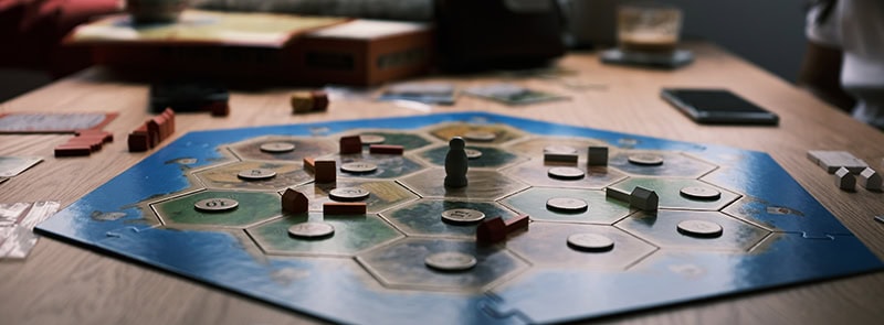 The board game Catan with pieces on an octagon-shaped board