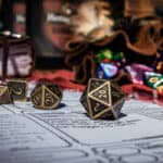 Dungeons and dragons dice are spilled onto a character sheet. A d20 is facing the camera.